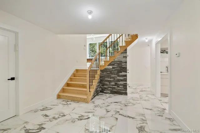 a living room with wooden floor furniture and a window