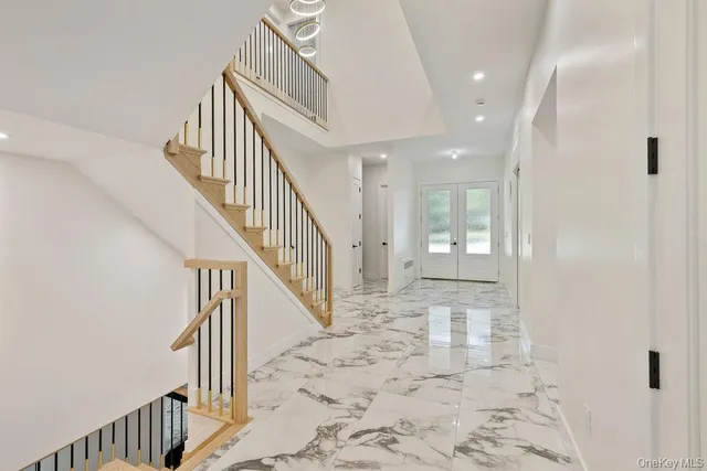 a view of a hallway with wooden floor and entryway