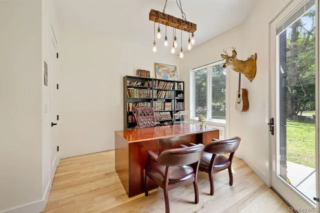 a view of a dining room with furniture window and wooden floor