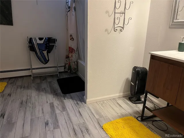 a view of a workspace with wooden floor