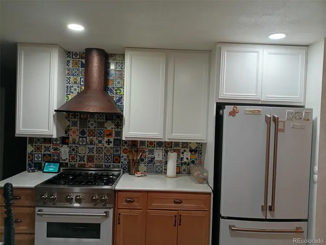 a kitchen with stainless steel appliances a stove a refrigerator a sink and cabinets