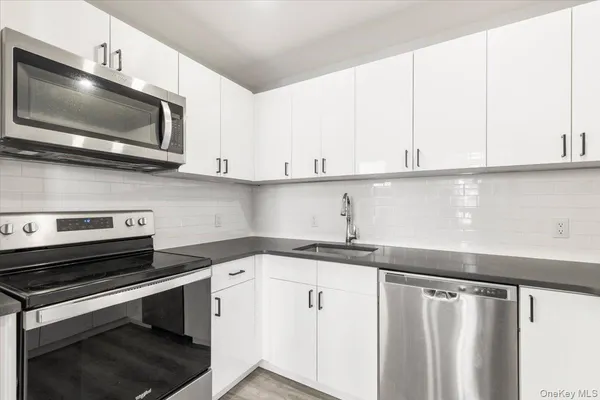 a kitchen with a sink and a microwave