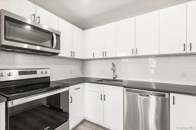 a kitchen with a sink and a microwave
