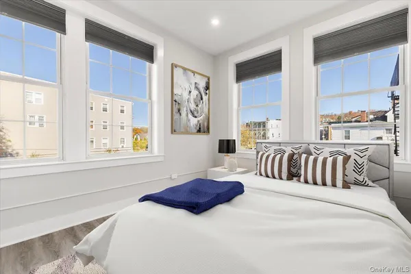 a bedroom with a large bed and a window