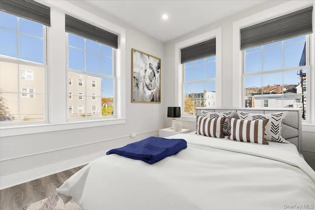 a bedroom with a large bed and a window