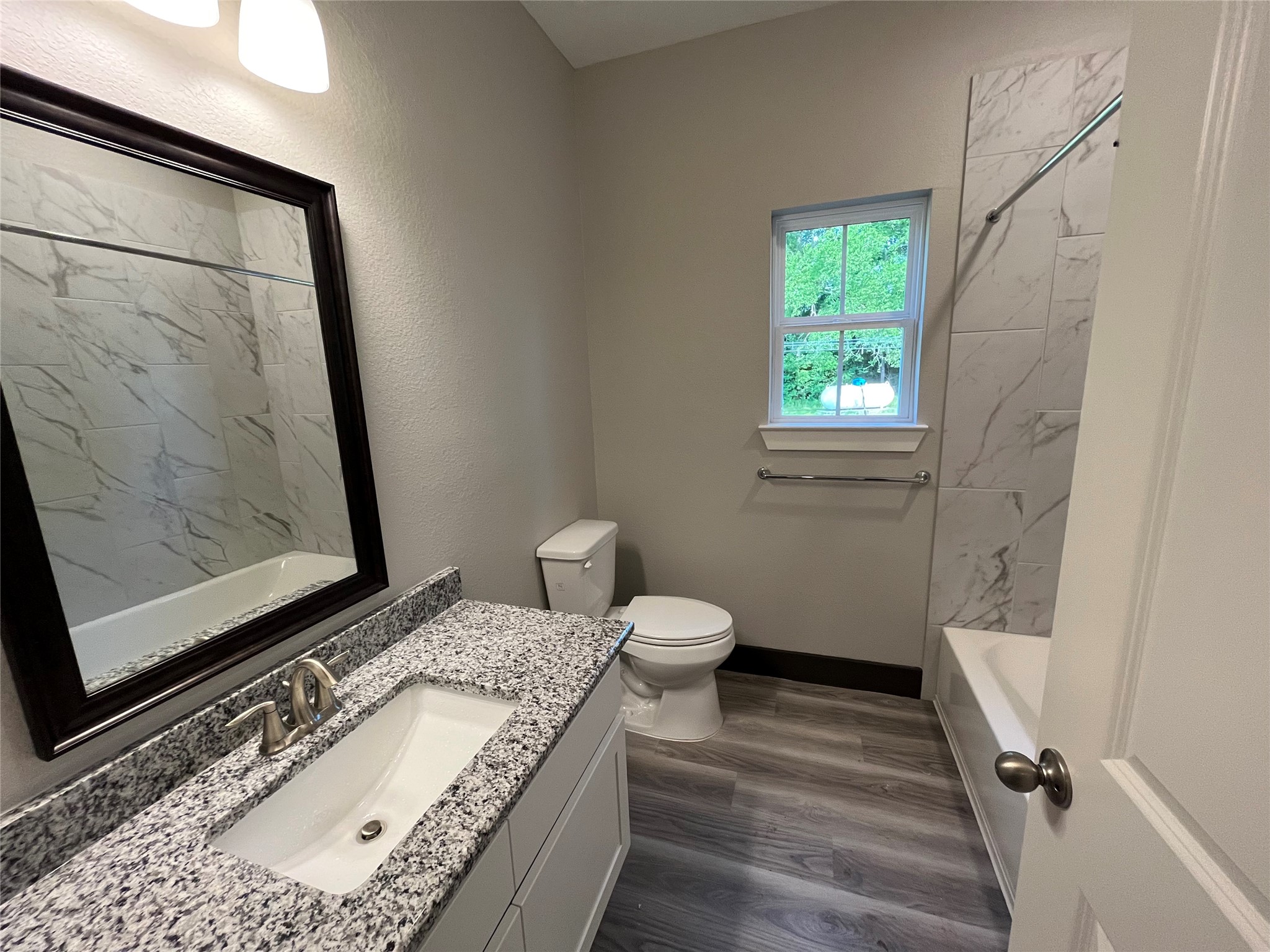 111 Heatherbrook Somerville, TX 77879 - Photo 7 of 11 a bathroom with a granite countertop sink and a mirror