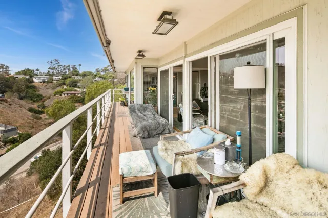 a balcony with table and chairs
