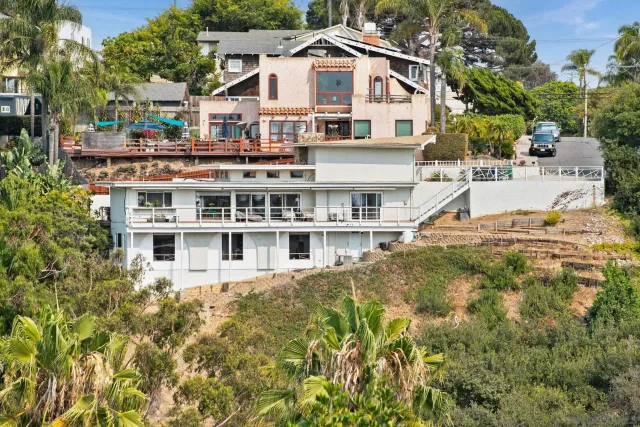 a view of a white house with a large pool