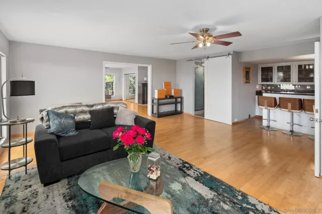 a living room with furniture and kitchen view