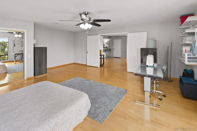 a bedroom with a bed and chandelier