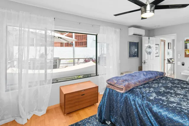 a bedroom with a bed and a window