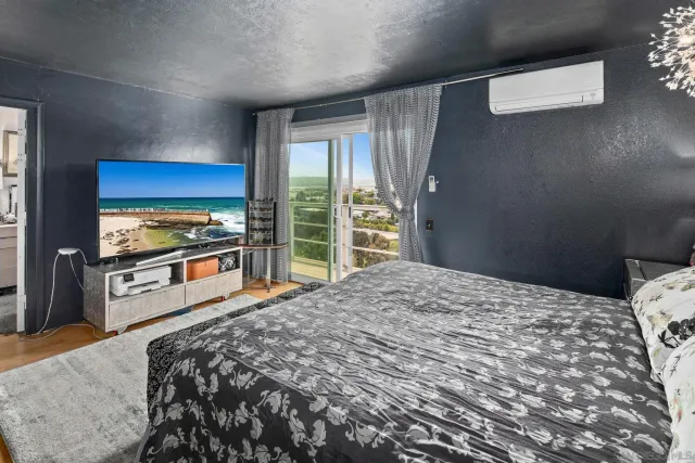 a bedroom with a bed and a large window