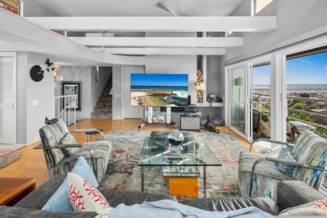 a living room with furniture a rug and a chandelier