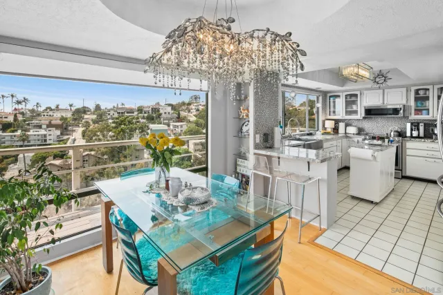 a view of a dining room with furniture a chandelier and wooden floor