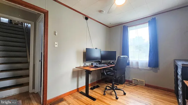 a view of a workspace with furniture and a window
