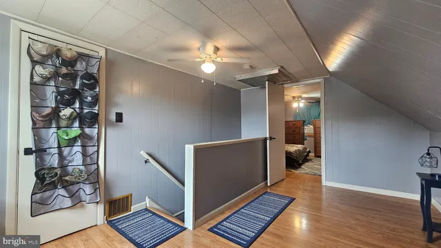 a bedroom with a bed and a chandelier fan