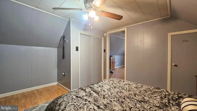a bedroom with a bed and a refrigerator