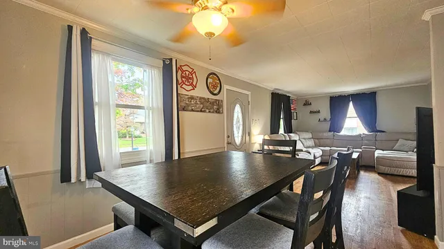 a view of a hallway with entryway wooden floor and front door