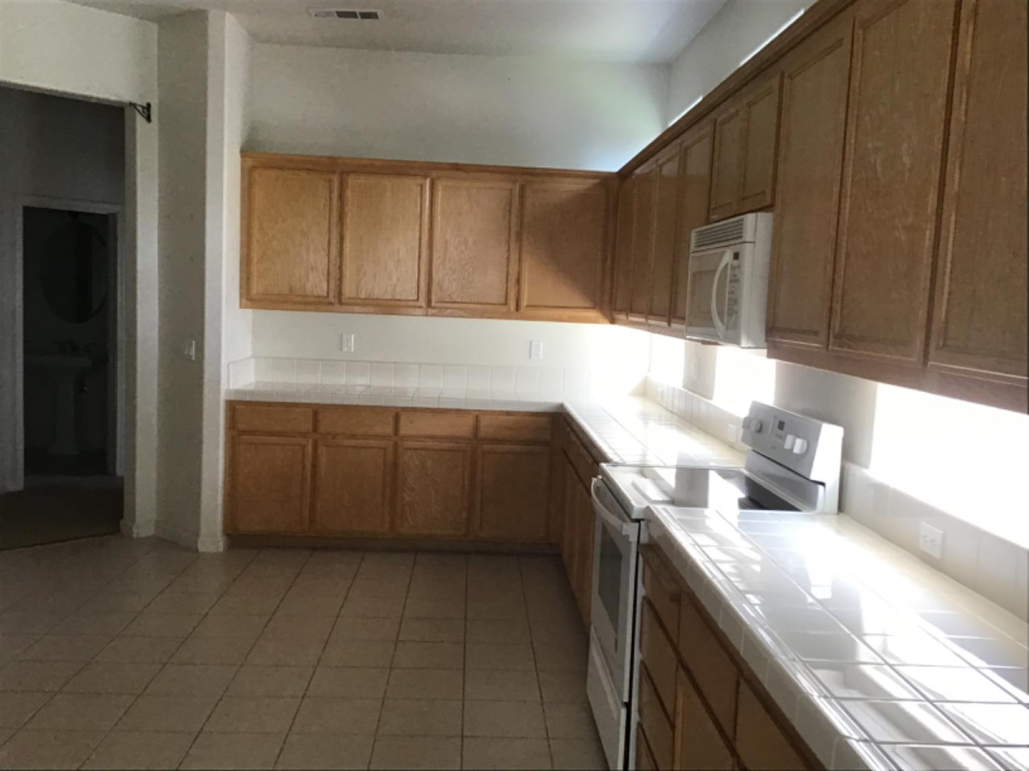205 Quail Meadow Lane Copperopolis, CA 95228 - Photo 15 of 27 a kitchen with a sink a stove and cabinets