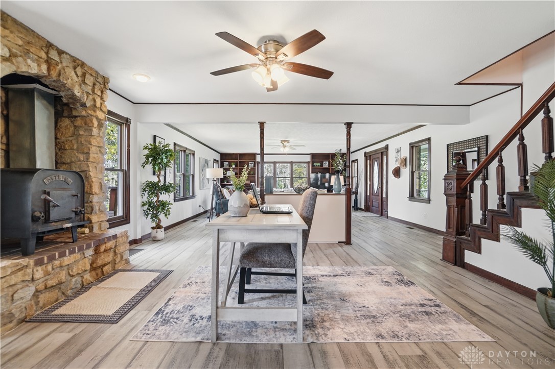 7553 Coffin Station Road Springfield, OH 45502 - Photo 37 of 95 This expansive interior offers abundant natural light, a striking stone fireplace, and elegant wood flooring throughout.