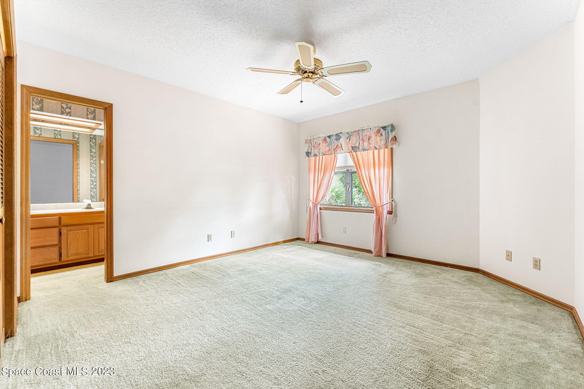 3700 Shady Run Road Melbourne, FL 32934 - Photo 14 of 27 an empty room with fan and windows