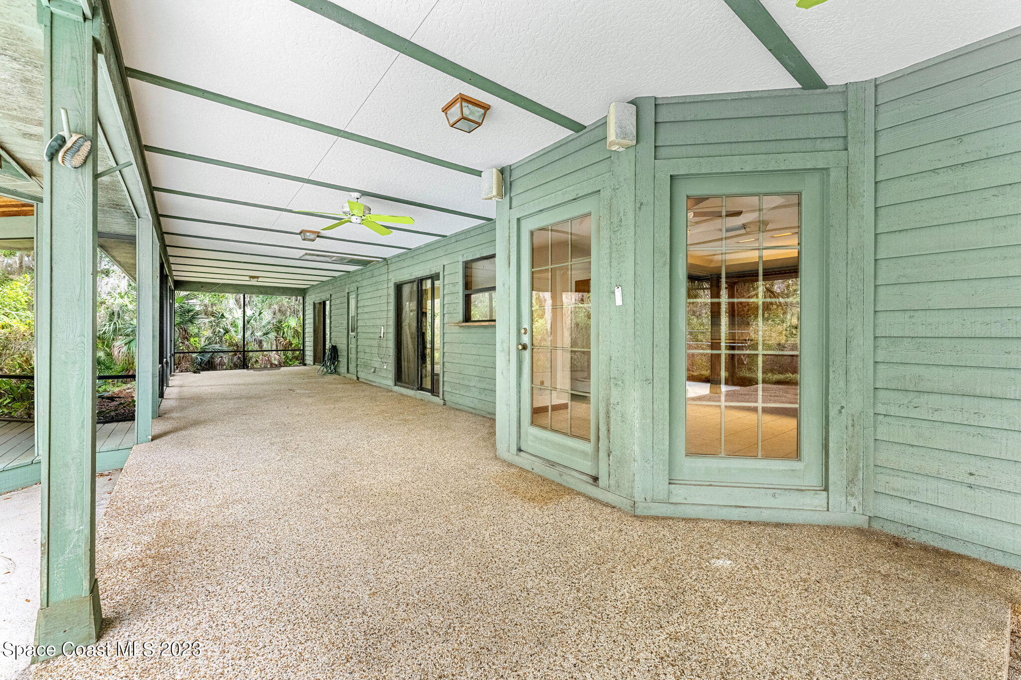 3700 Shady Run Road Melbourne, FL 32934 - Photo 17 of 27 a view of a big room with wooden floor and windows