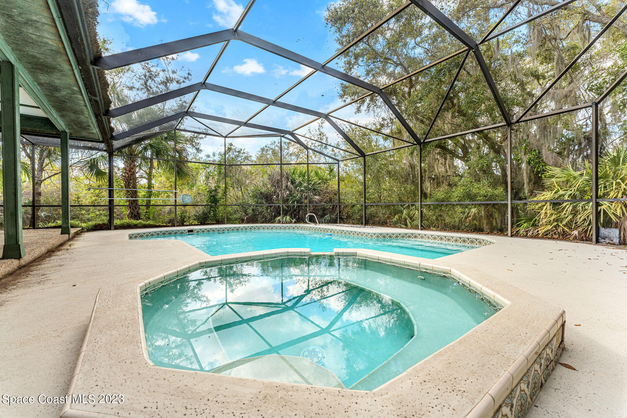 3700 Shady Run Road Melbourne, FL 32934 - Photo 18 of 27 a view of a swimming pool with a patio