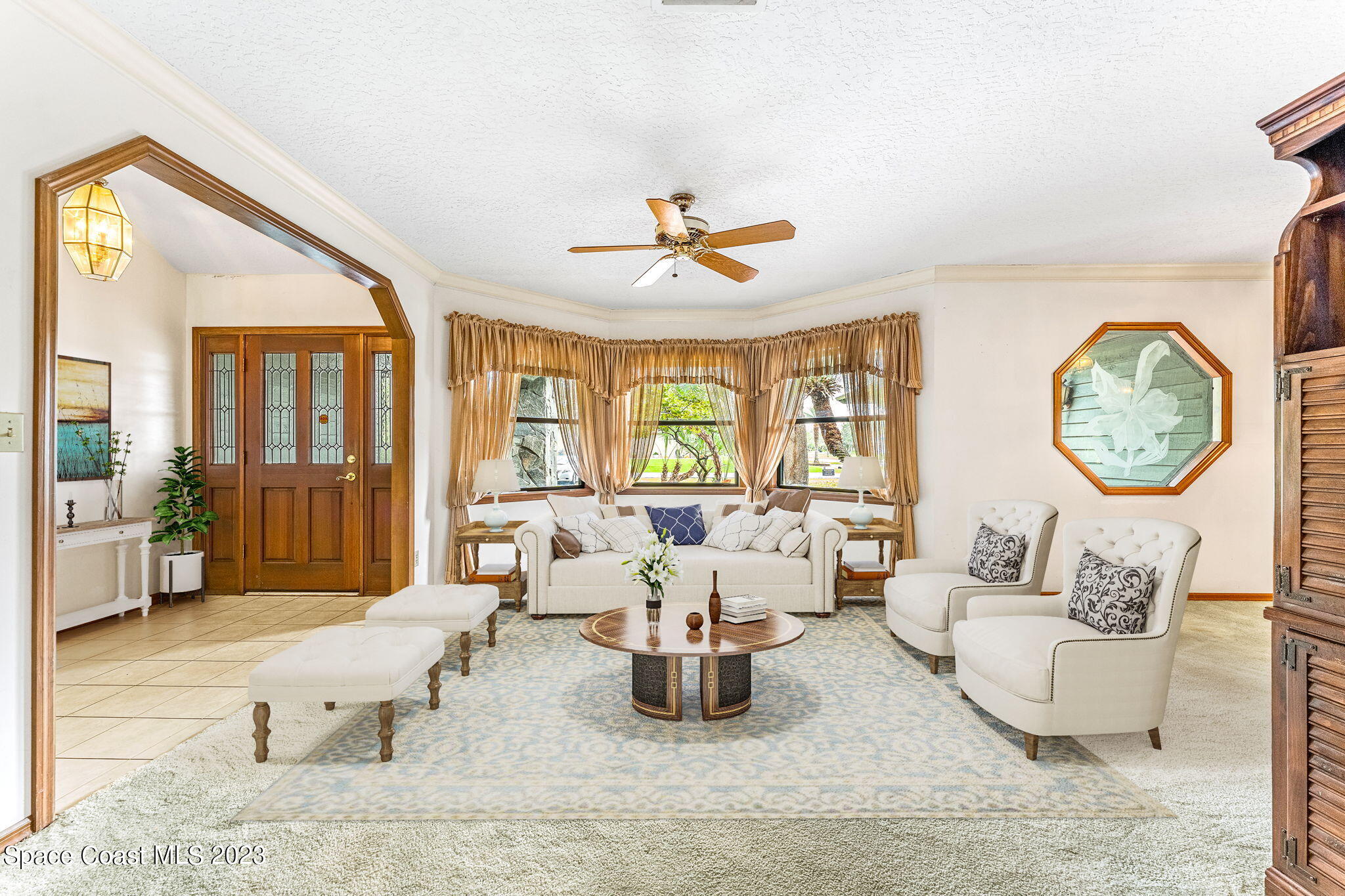 3700 Shady Run Road Melbourne, FL 32934 - Photo 3 of 27 a living room with furniture dining table and a large window