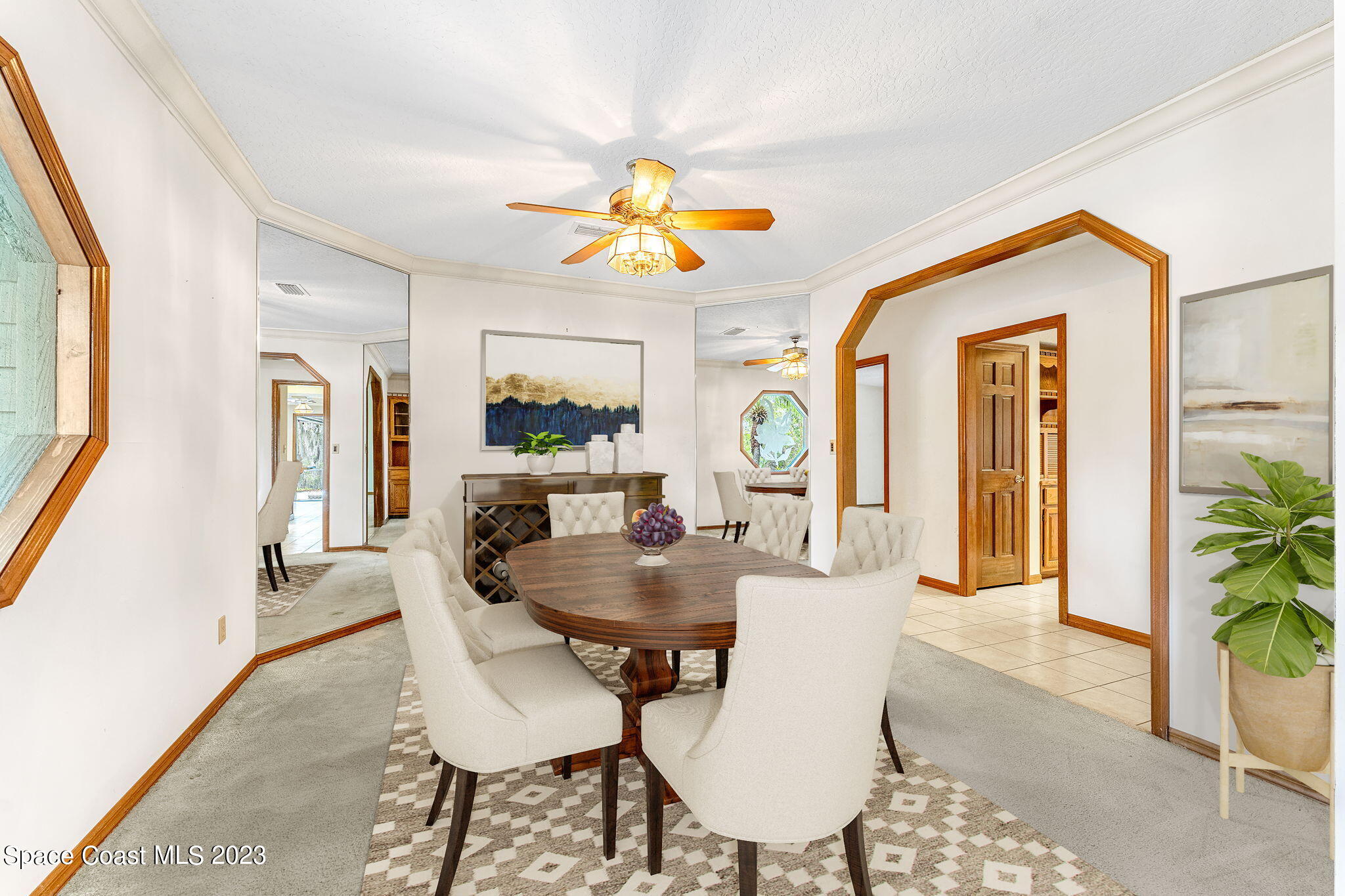 3700 Shady Run Road Melbourne, FL 32934 - Photo 4 of 27 a dining room with furniture a livingroom and chandelier