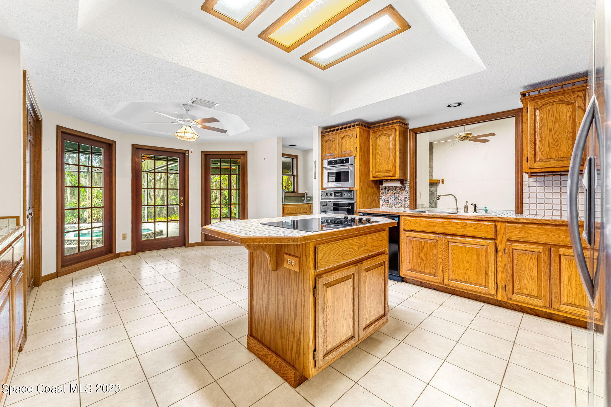 3700 Shady Run Road Melbourne, FL 32934 - Photo 6 of 27 a large kitchen with stainless steel appliances granite countertop a sink and cabinets