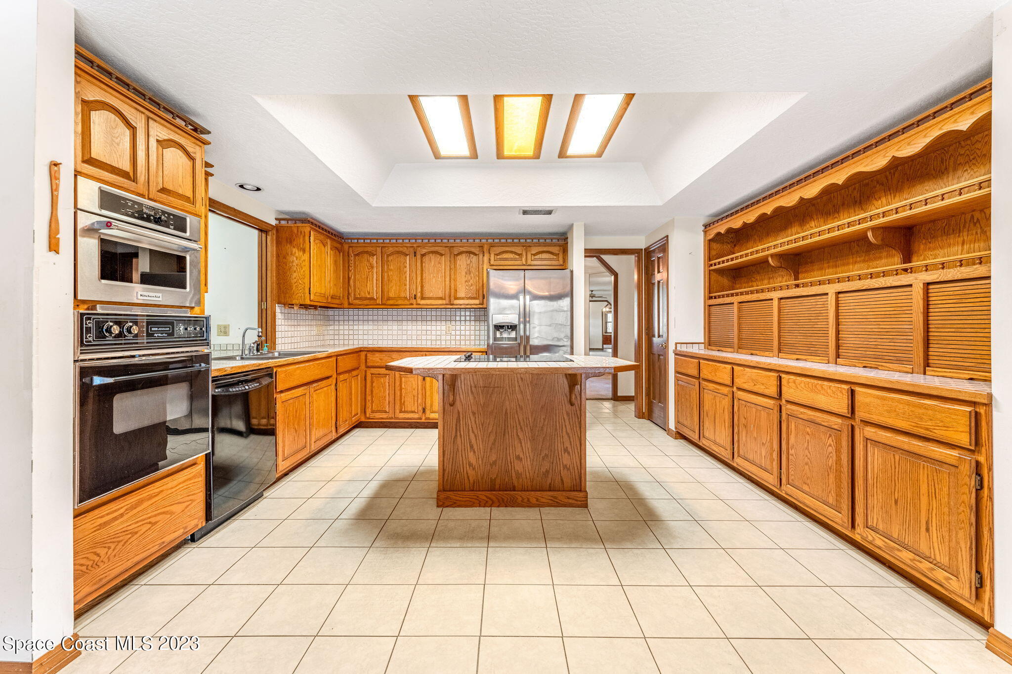 3700 Shady Run Road Melbourne, FL 32934 - Photo 7 of 27 a large kitchen with stainless steel appliances kitchen island granite countertop a large stove top oven a sink dishwasher and cabinets