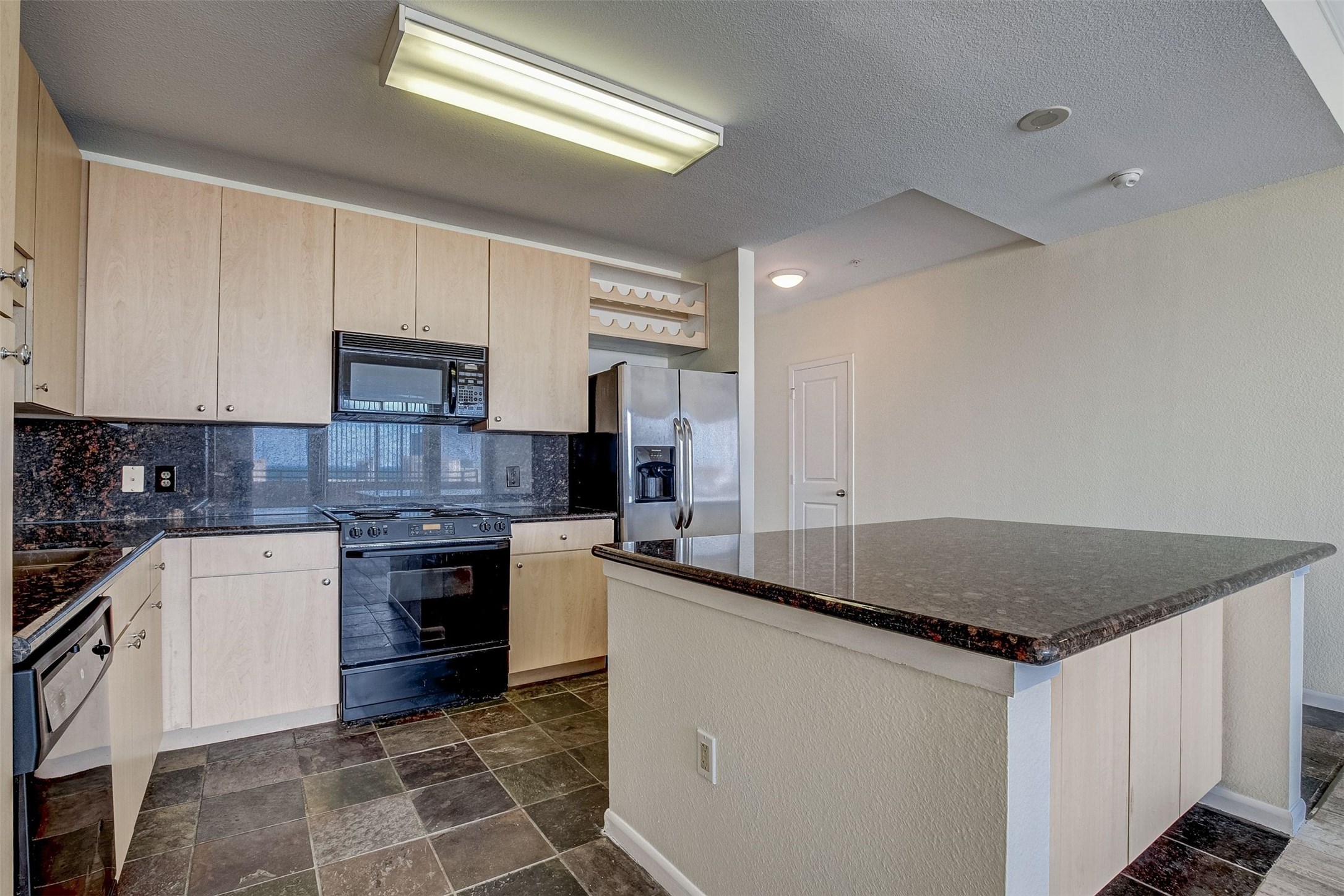 3505 Sage Road, Unit 2403 Houston, TX 77056 - Photo 11 of 26 a kitchen with stainless steel appliances granite countertop a stove sink and cabinets