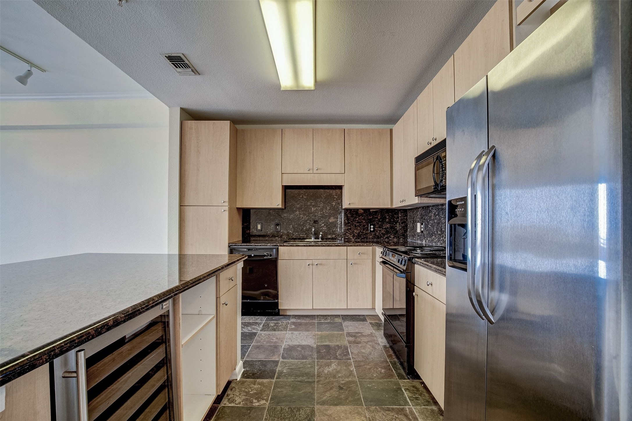 3505 Sage Road, Unit 2403 Houston, TX 77056 - Photo 13 of 26 a kitchen with a refrigerator sink and cabinets