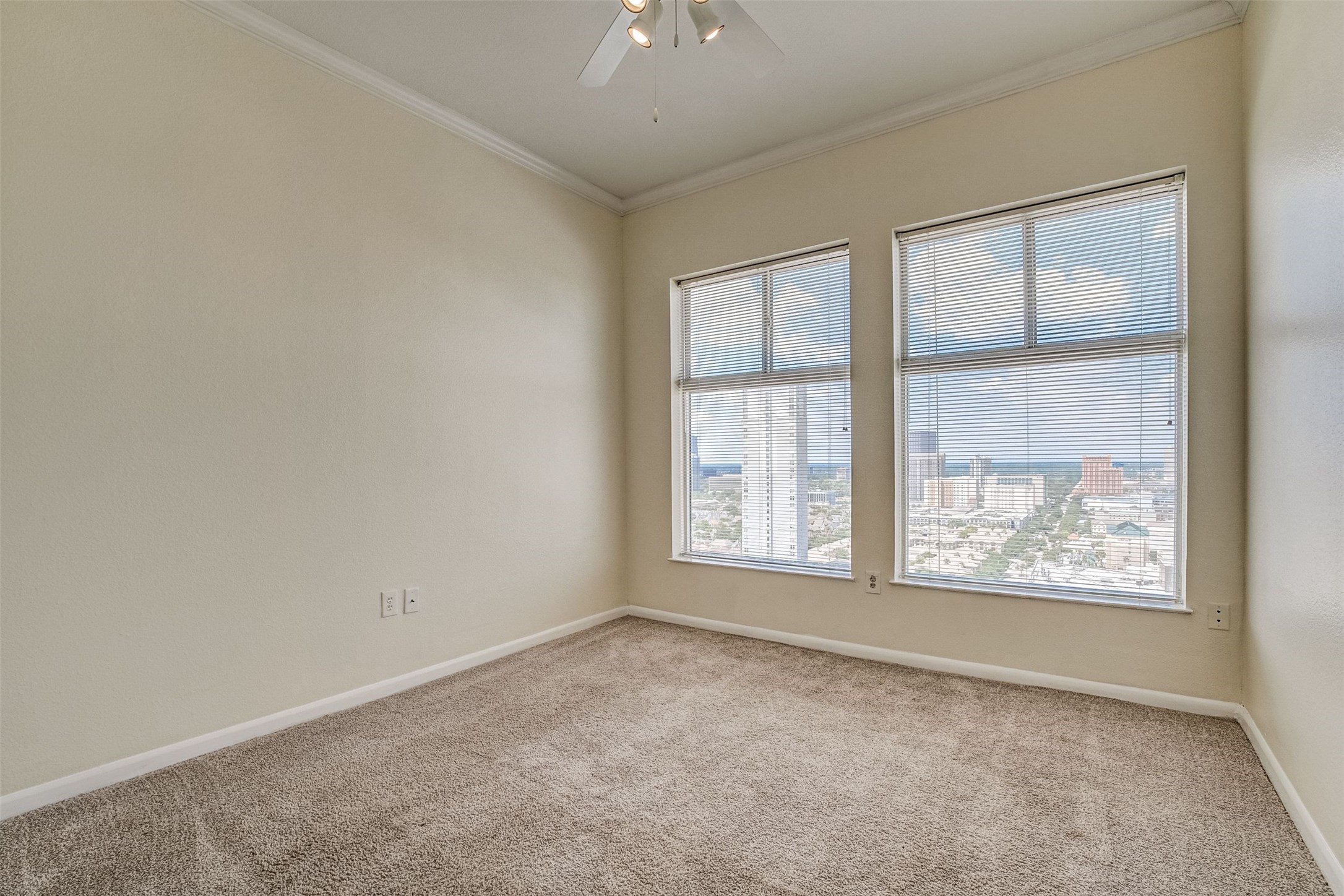 3505 Sage Road, Unit 2403 Houston, TX 77056 - Photo 19 of 26 an empty room with windows and chandelier fan