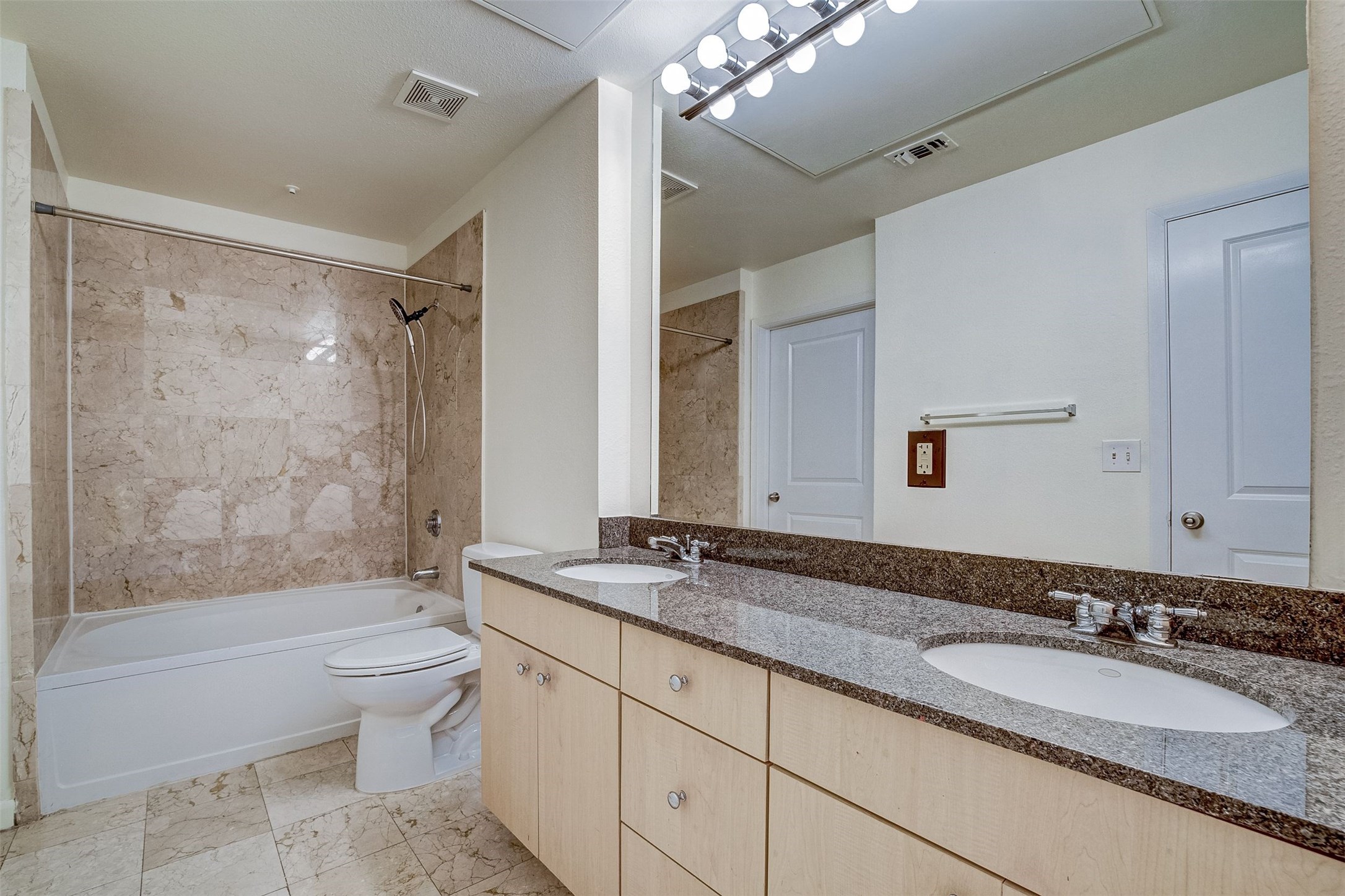 3505 Sage Road, Unit 2403 Houston, TX 77056 - Photo 22 of 26 a bathroom with a granite countertop double vanity sink toilet mirror and bathtub
