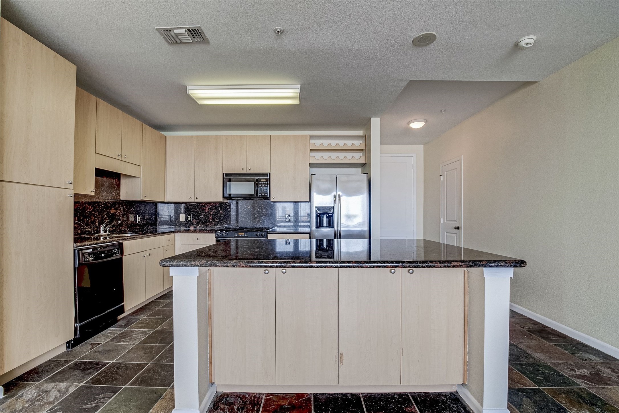 3505 Sage Road, Unit 2403 Houston, TX 77056 - Photo 10 of 26 a kitchen with stainless steel appliances granite countertop a sink and a refrigerator