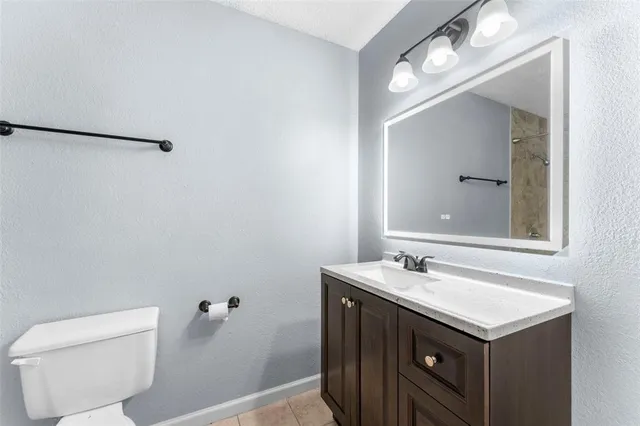 a bathroom with a sink vanity and a mirror