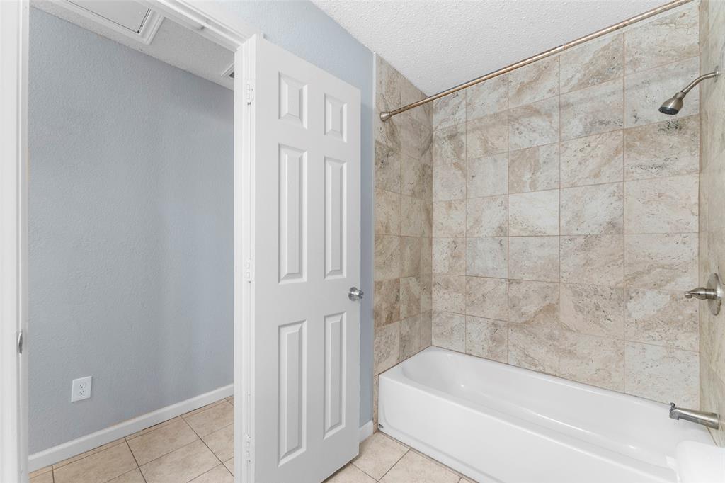 1042 Kim Lane Mesquite, TX 75149 - Photo 13 of 16 a bathroom with a bathtub and shower