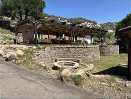 a view of a backyard with table and chairs and a fire pit