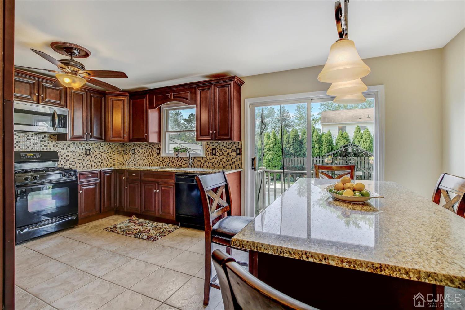 7 Park Place Helmetta, NJ 08828 - Photo 13 of 33 a kitchen with a stove a sink and a refrigerator