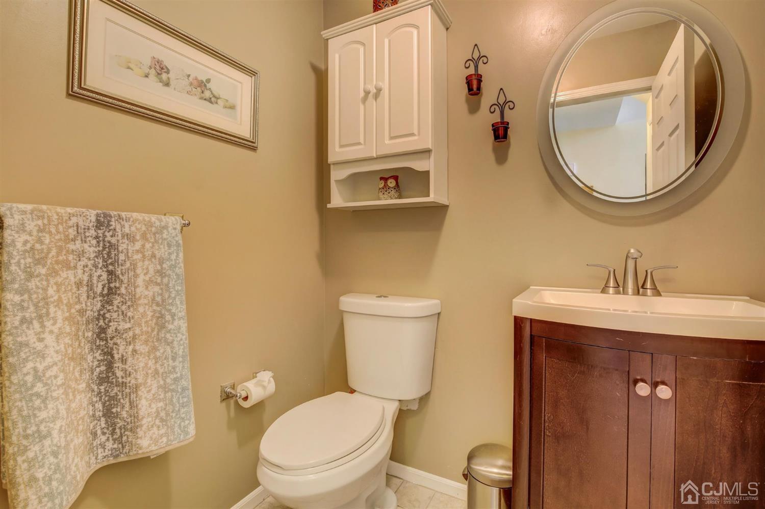 7 Park Place Helmetta, NJ 08828 - Photo 16 of 33 a bathroom with a toilet a sink and a mirror