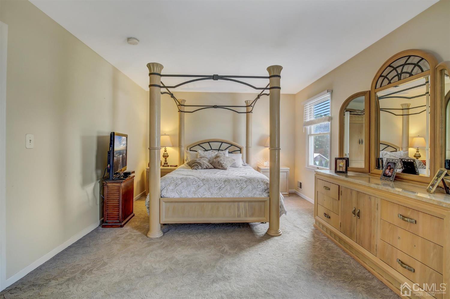 7 Park Place Helmetta, NJ 08828 - Photo 19 of 33 a bedroom with a bed and a mirror