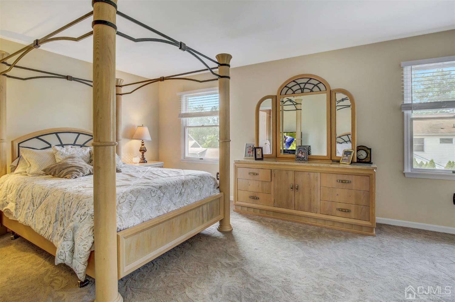 7 Park Place Helmetta, NJ 08828 - Photo 20 of 33 a bedroom with a bed and a mirror on the dresser
