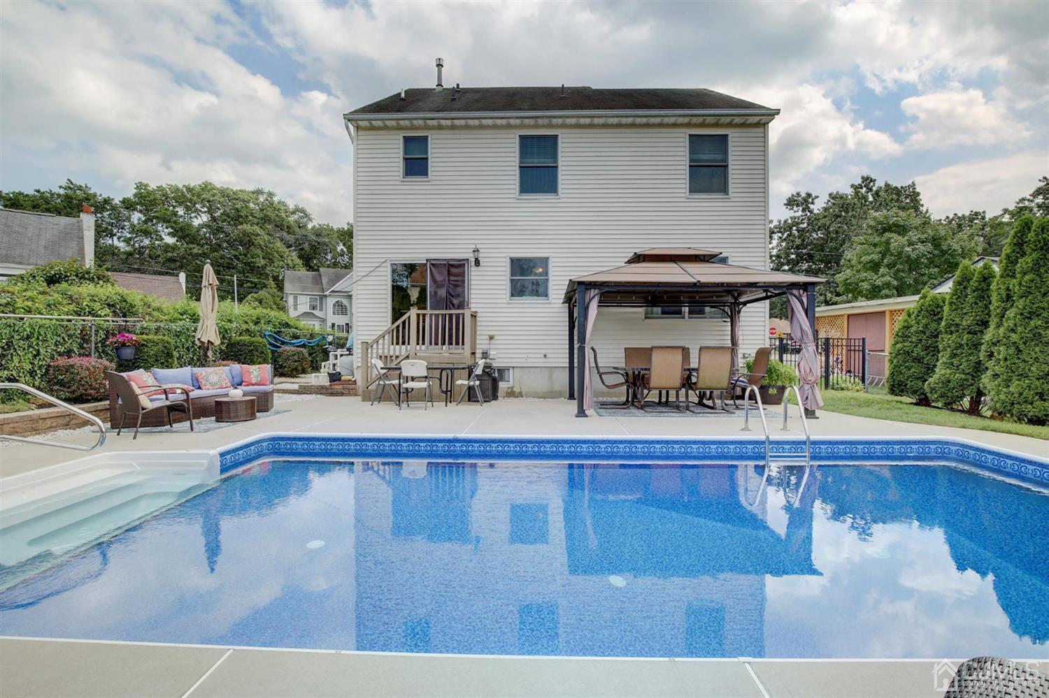 7 Park Place Helmetta, NJ 08828 - Photo 29 of 33 a view of a house with swimming pool and sitting area