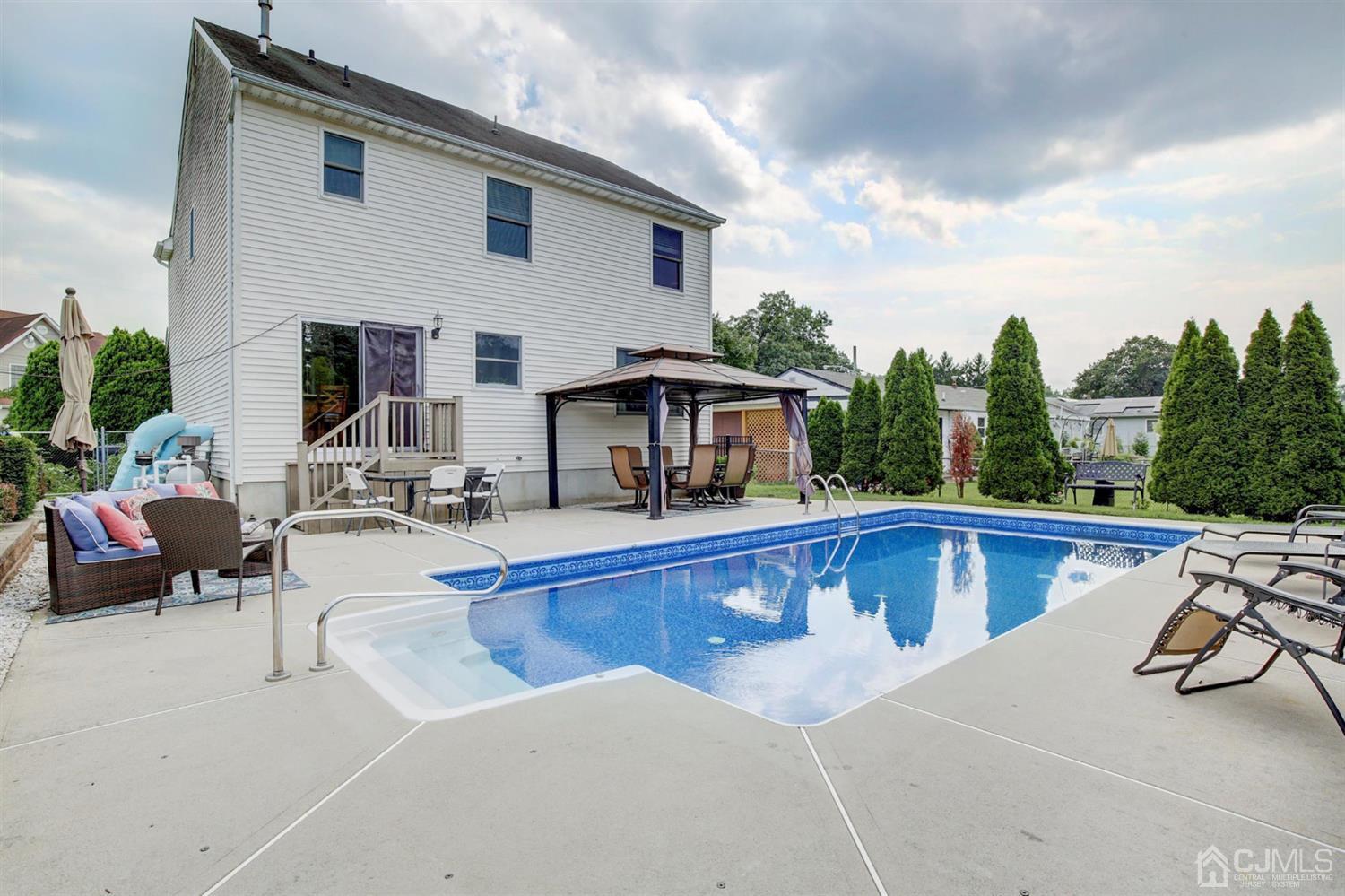 7 Park Place Helmetta, NJ 08828 - Photo 30 of 33 a view of a house with swimming pool and sitting area