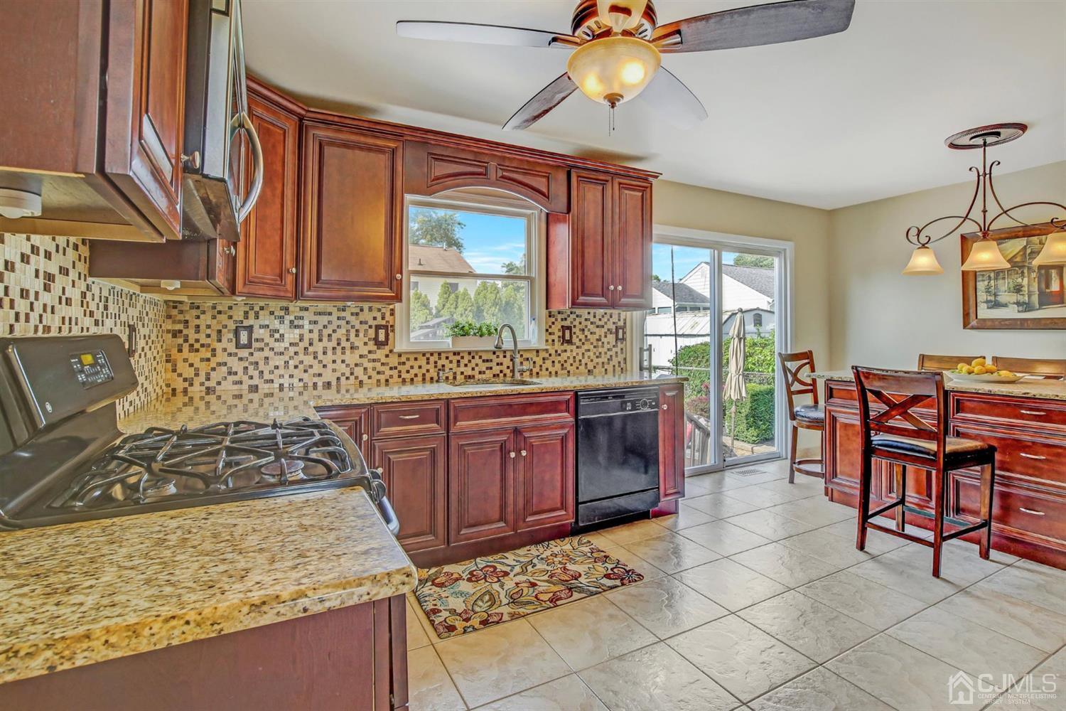 7 Park Place Helmetta, NJ 08828 - Photo 8 of 33 a kitchen with stainless steel appliances granite countertop a stove a sink and a microwave