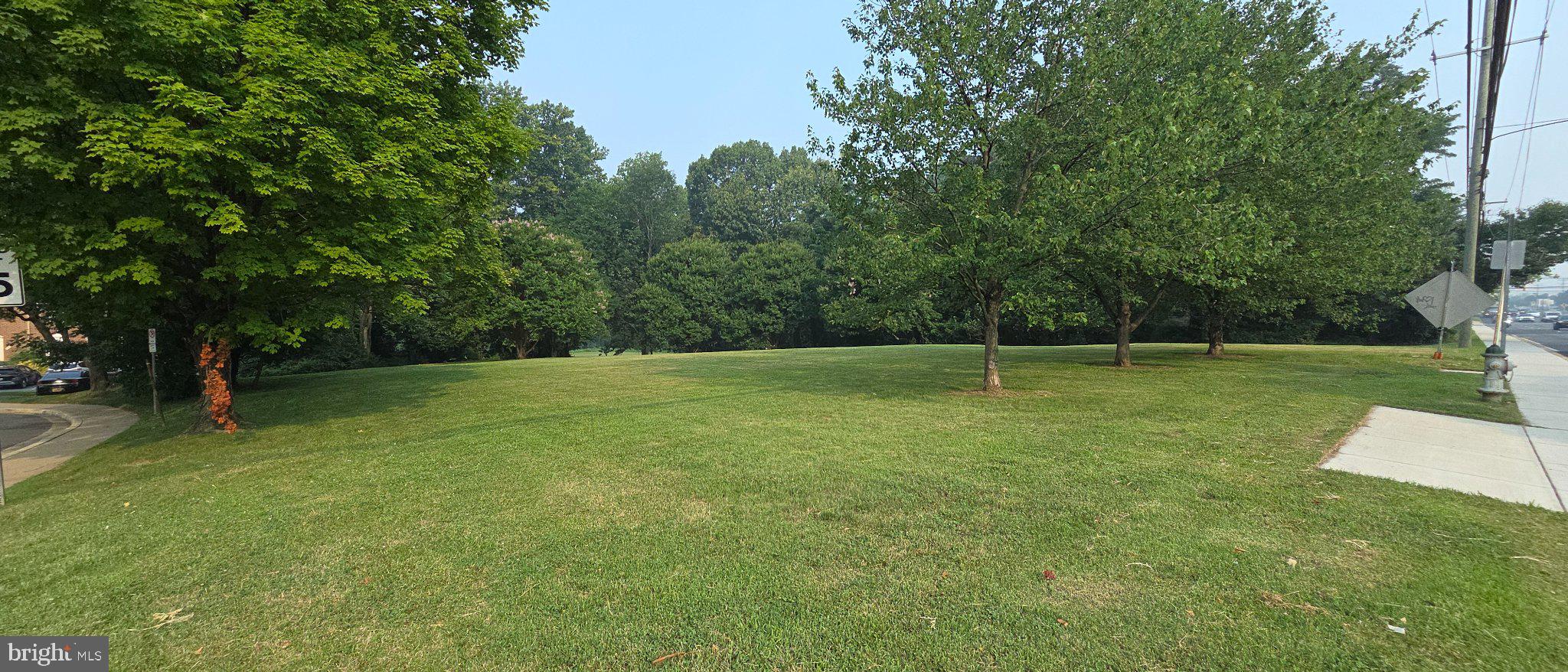 506 Pickwick Village Way Silver Spring, MD 20901 - Photo 30 of 31 Lush green space under clear skies.