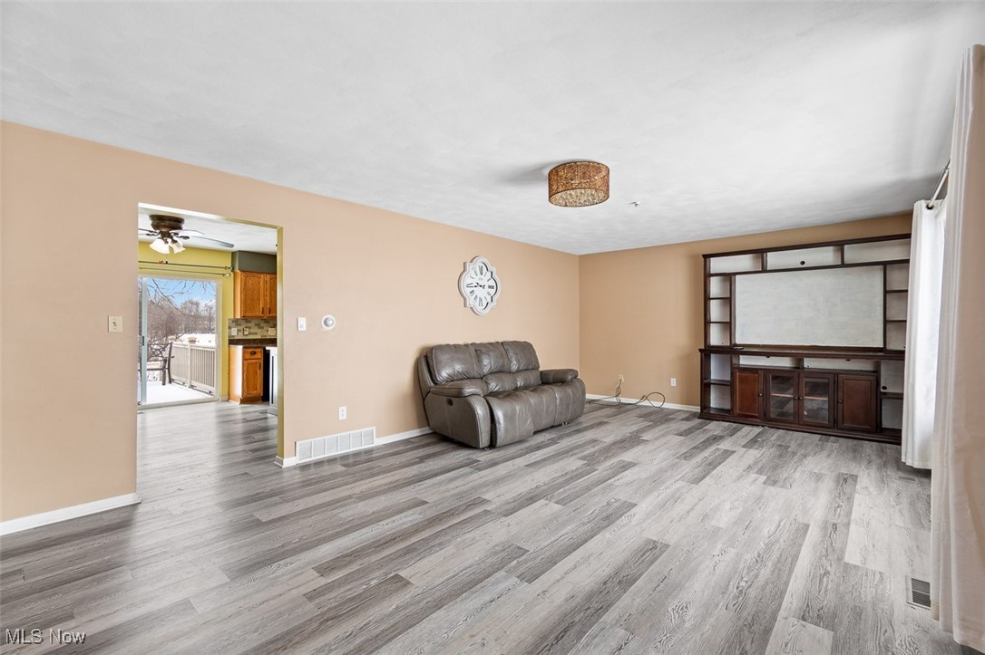 5208 Canaan Center Road Wooster, OH 44691 - Photo 5 of 33 Living room with wood finished floors, visible vents, and baseboards