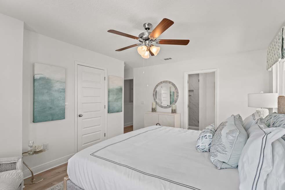 11 Redbird Loop Destin, FL 32541 - Photo 21 of 30 a bedroom with a bed and a chandelier
