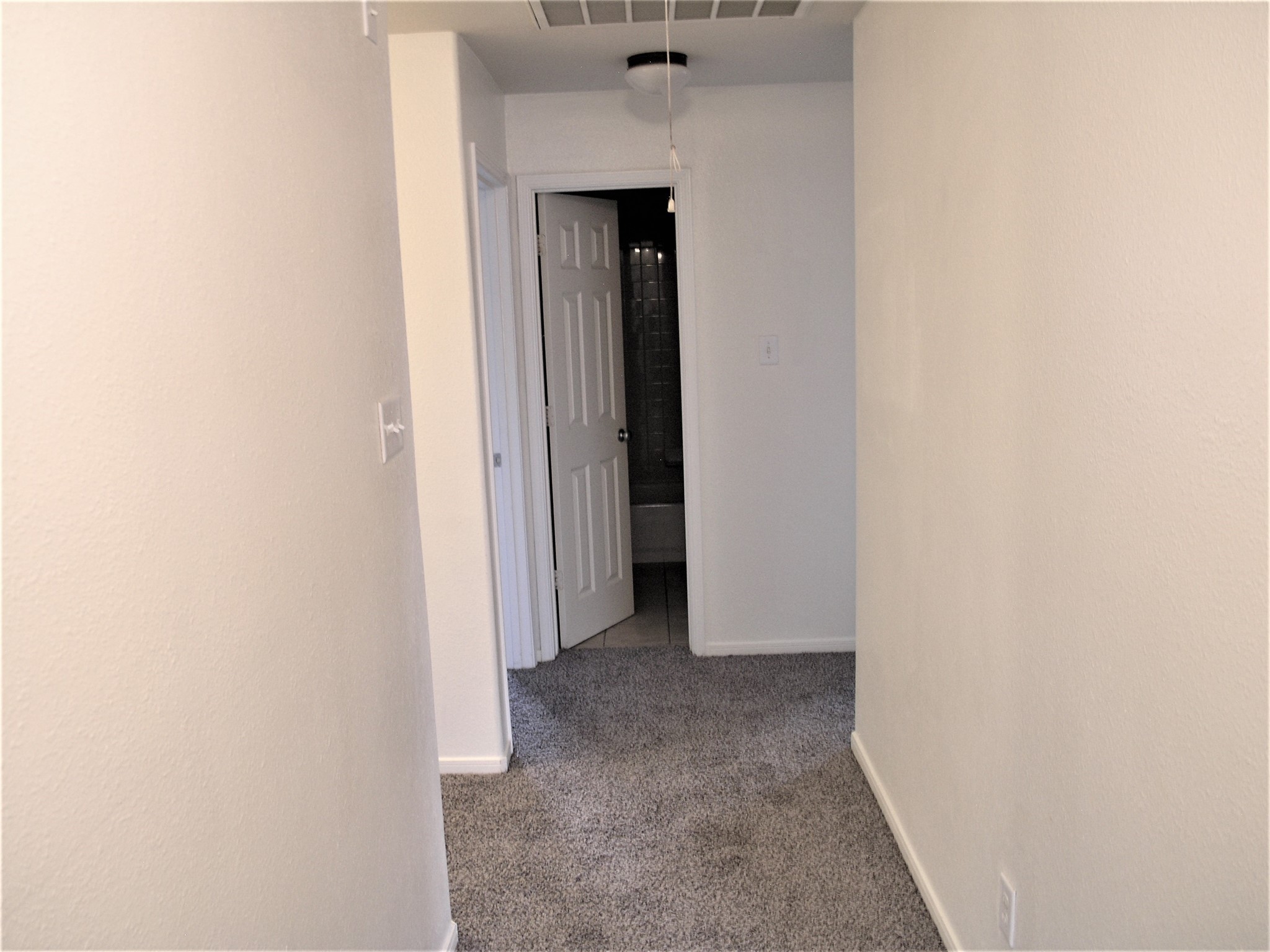 2926 Meadowglen Crest Houston, TX 77082 - Photo 20 of 22 Hallway from Primary to Stairs and Bedroom 1 and 2 and upstairs Bathroom